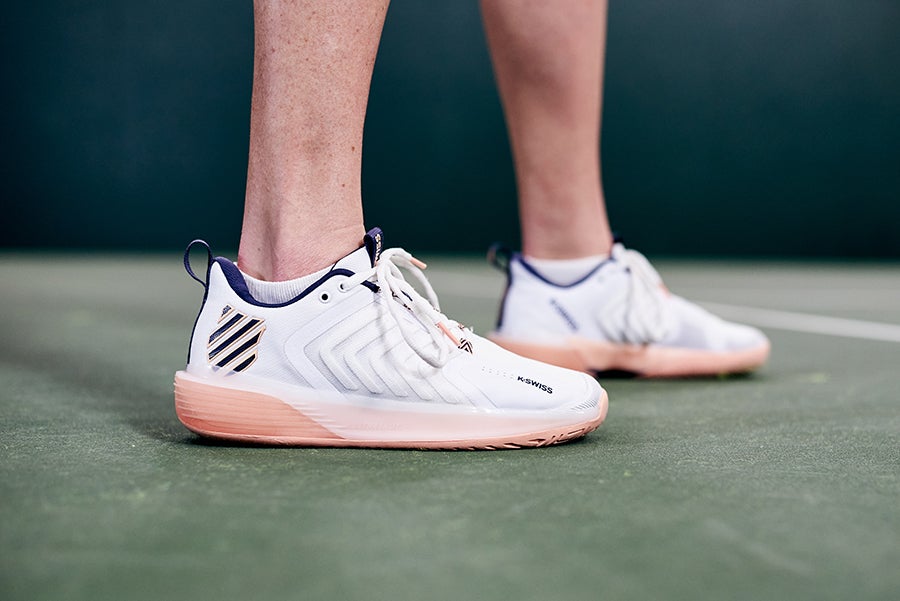 Well cushioned tennis shoes absorbing a hard landing on astro turf