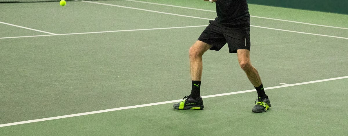 Player planting hard for a lateral move on astro turf