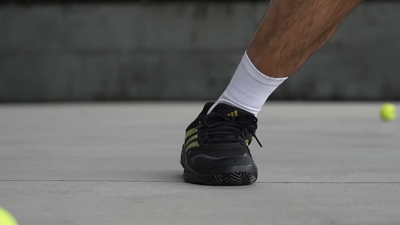 adidas CourtJam Control 3 player planting on a hard court