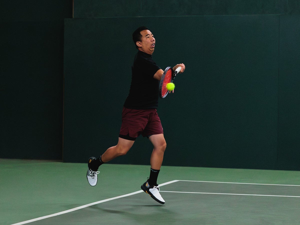 K-Swiss Ultrashot Team player lunging on an indoor court