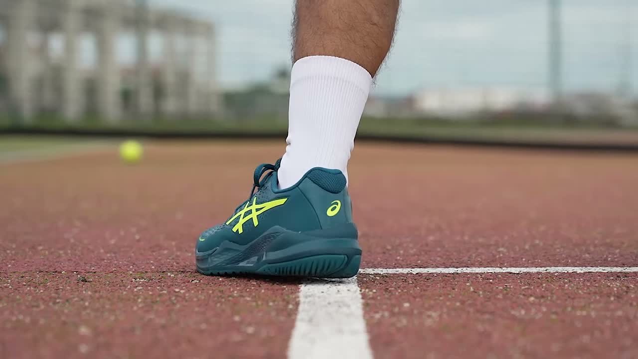 ASICS Gel-Challenger 14 player planted on clay during a lateral move