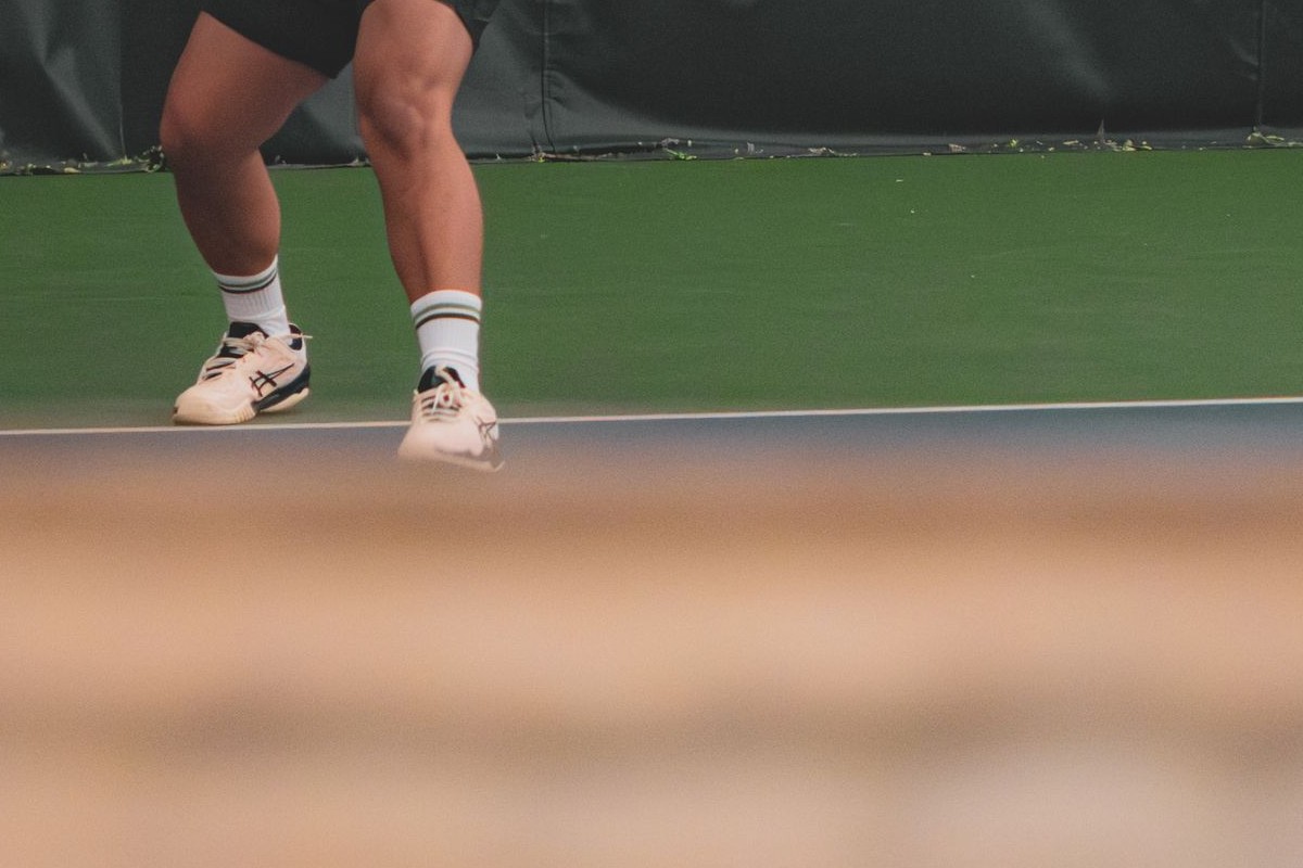 Applying shoe repair glue to tennis shoe